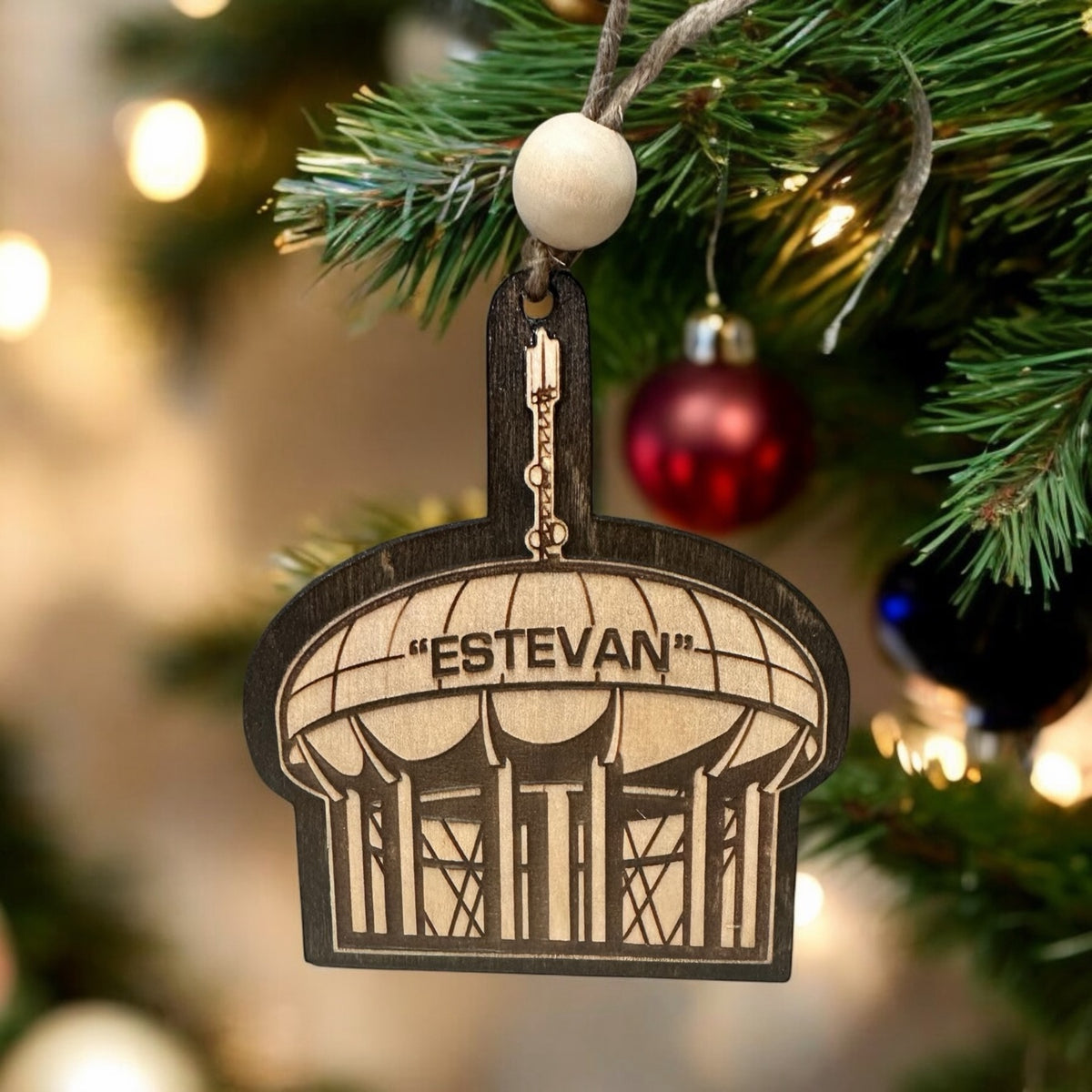 Estevan water tower wood Christmas ornament hanging on a tree